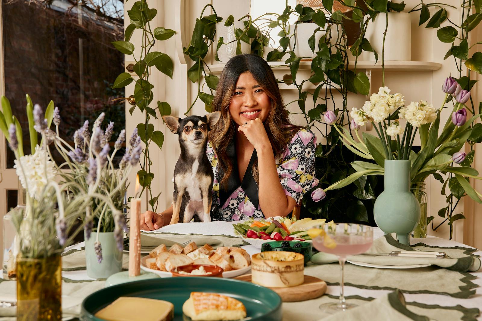 Jess Nguyen sits at her stunning table with her dog, Pabla.
